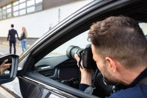 Private investigator conducting surveillance in a city setting